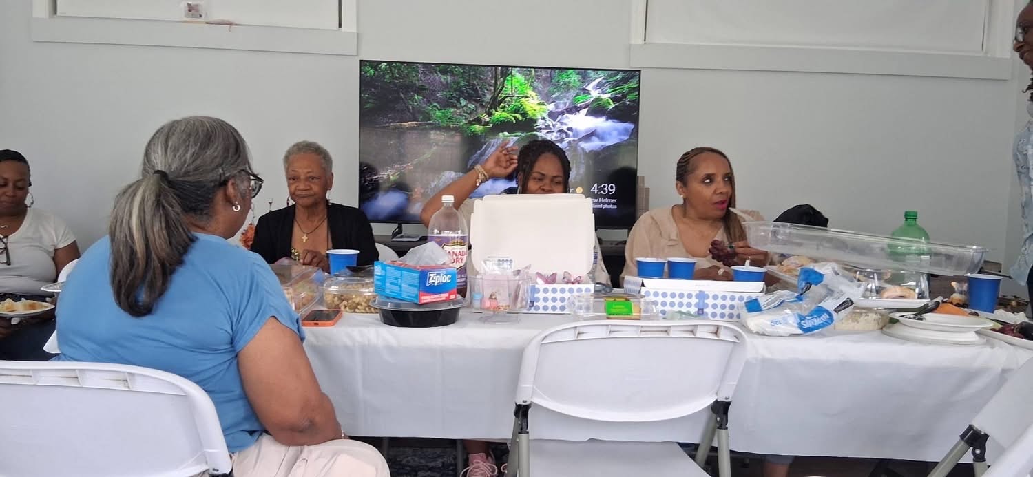 S.A.F.E. Sisters gathered around a table for a meeting